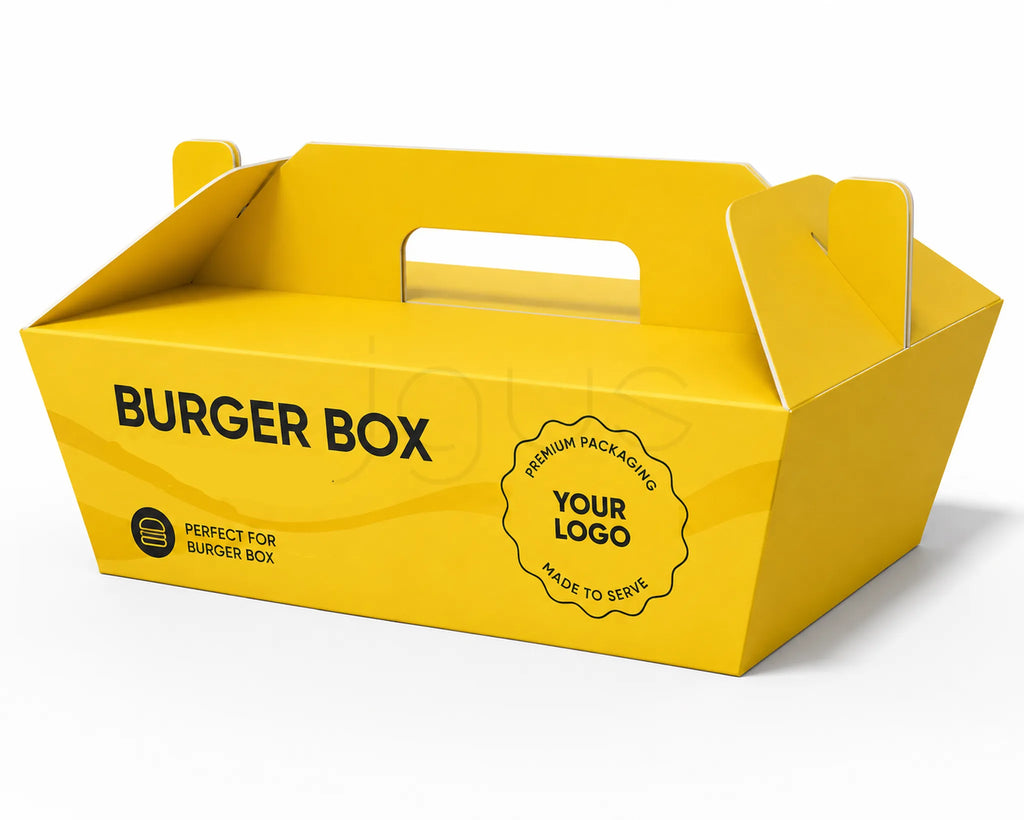 A bright yellow cardboard burger box with built-in handles, printed with the words 'BURGER BOX' and a circular badge reading 'PREMIUM PACKAGING YOUR LOGO MADE TO SERVE,' shown on a clean white background.