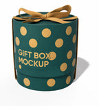 A cylindrical gift box mockup in dark teal with gold polka dots and a gold ribbon bow on top, featuring the text 'GIFT BOX MOCKUP' on the front, set against a plain white background.