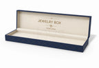 An open luxury jewelry box with a navy blue exterior featuring a subtle geometric pattern, and a cream-colored interior lined with the text 'JEWELRY BOX' and 'YOUR LOGO' in gold foil.