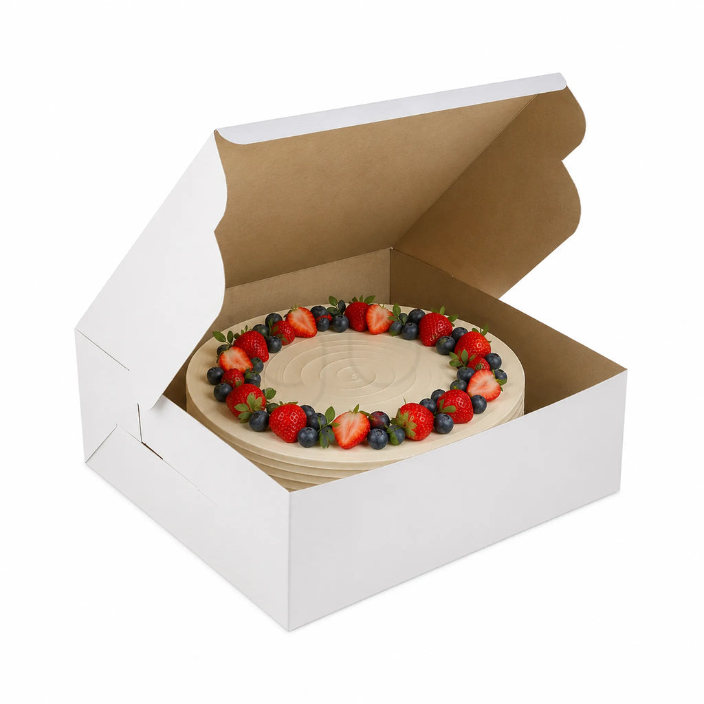 Fruit cake in a white cardboard cake box on a white background