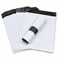 Stack of white mailing envelopes with black grey inside and adhesive for sealing