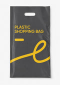 A dark gray plastic shopping bag with a die-cut handle, featuring yellow printed text that reads 'PLASTIC SHOPPING BAG' and a large yellow abstract line graphic on a white background.