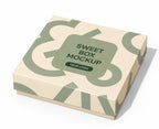 A square product box mockup with a cream and sage green geometric pattern, featuring a central label that reads 'SWEET BOX MOCKUP' and 'YOUR LOGO', shown on a white background.