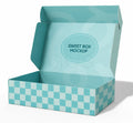 An open light blue cardboard sweet box mockup with a checkered pattern on the base and a circular 'SWEET BOX MOCKUP' label on the inside lid, shown on a white background.